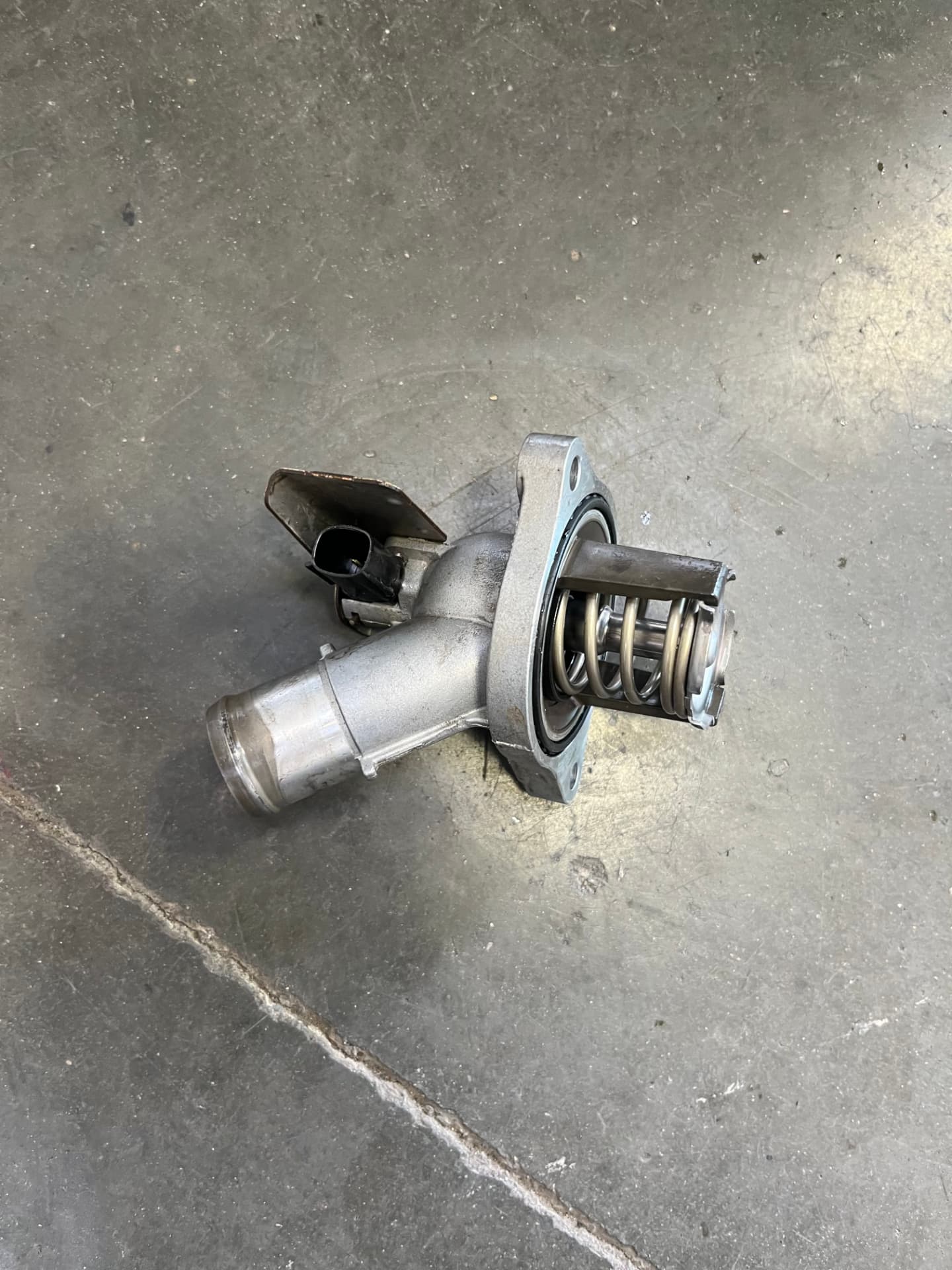 Thermostat removed from a Chevrolet Colorado at Johnny's Auto Repair near Spring Valley Lake in Victorville CA