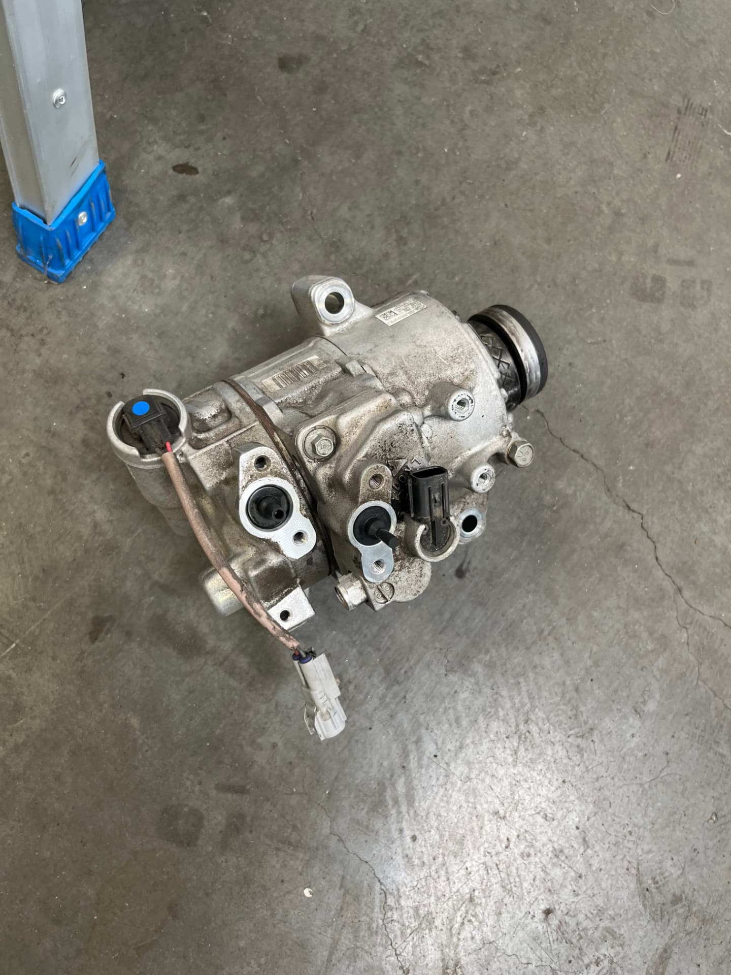 Removed Subaru air conditioning compressor at Johnny's Auto Repair near Spring Valley Lake in Victorville CA