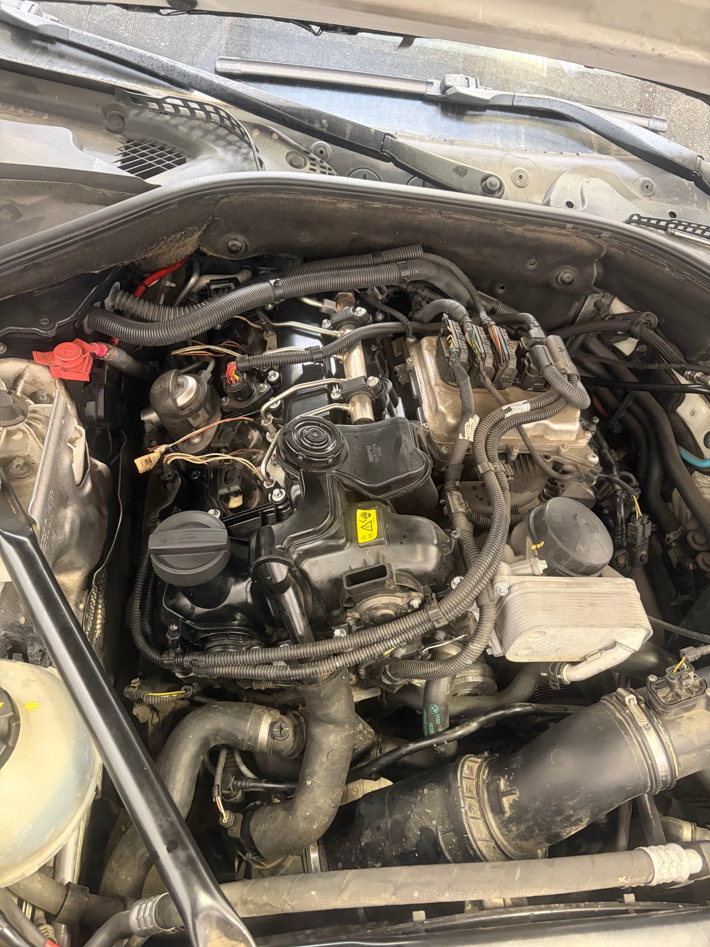 BMW engine with covers removed during repair at Johnny's Auto Repair on Ridgecrest Road in Victorville CA
